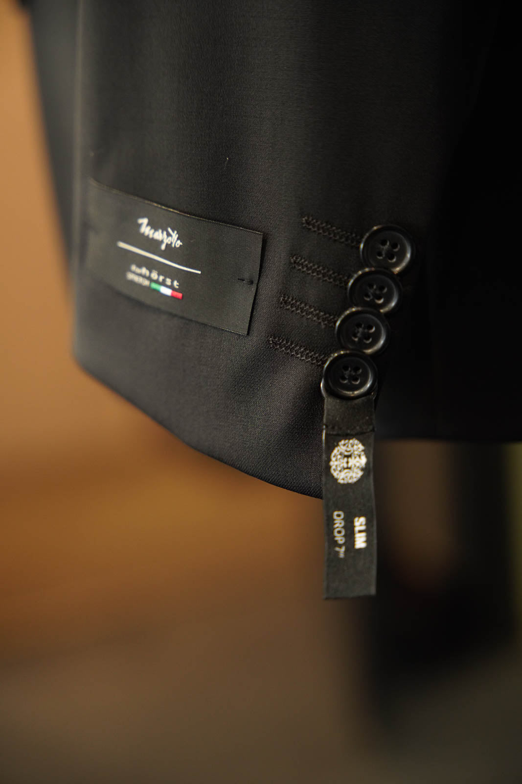 Horst black suit showing sleeve details with Marzotto fabric mill tag in Ultimo Euromoda store.