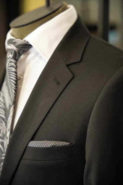 Horst black suit displayed on a mannequin with a notch lapel and black and silver tie in Ultimo Euromoda store.