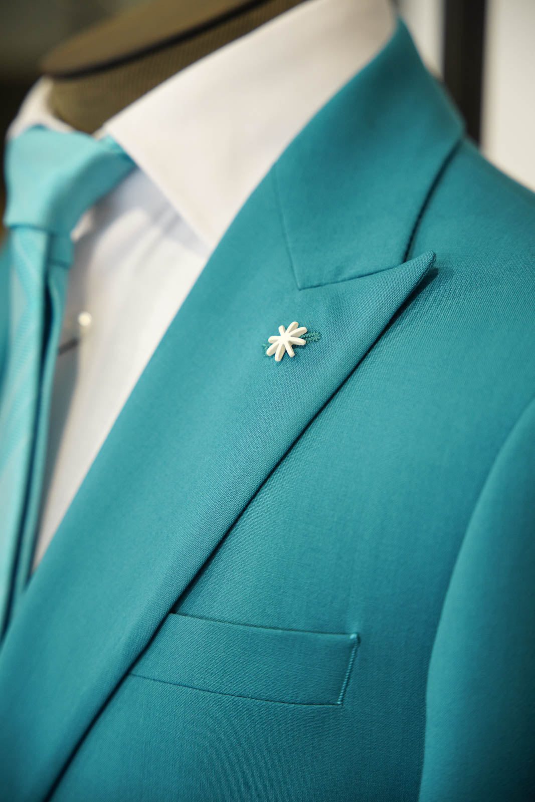 Manuel Ritz teal suit with a tonal teal paisley tie in Ultimo Euromoda store.